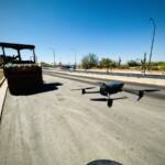 Drone launching from a construction site, ready to shoot footage of the project.